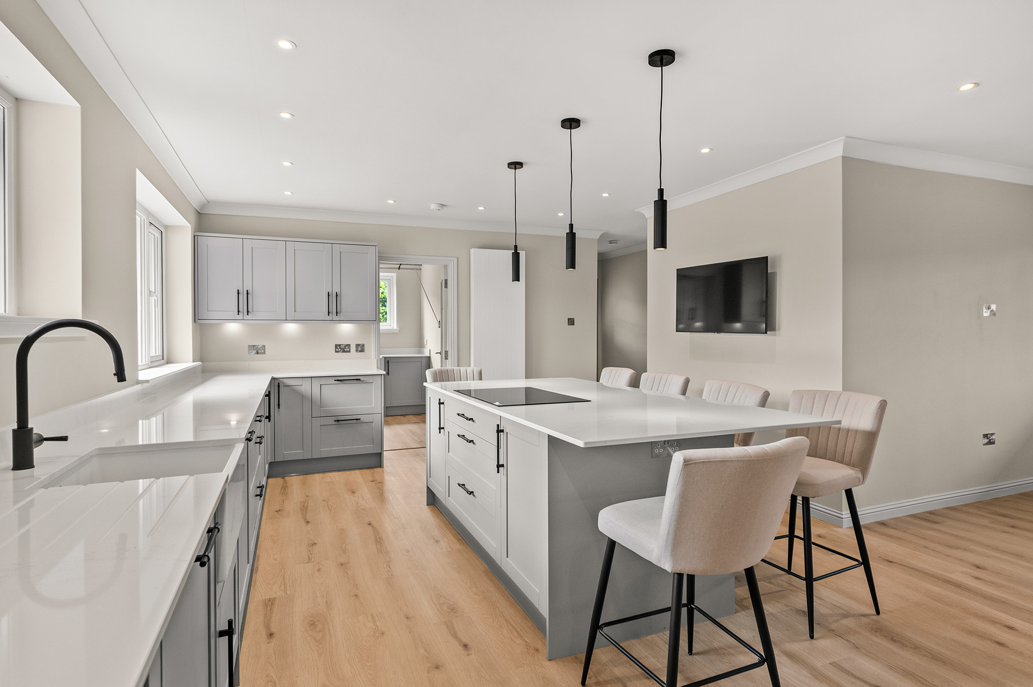 Kitchen at Auchterarder seen from the sink run, showing the island and shaker wall units