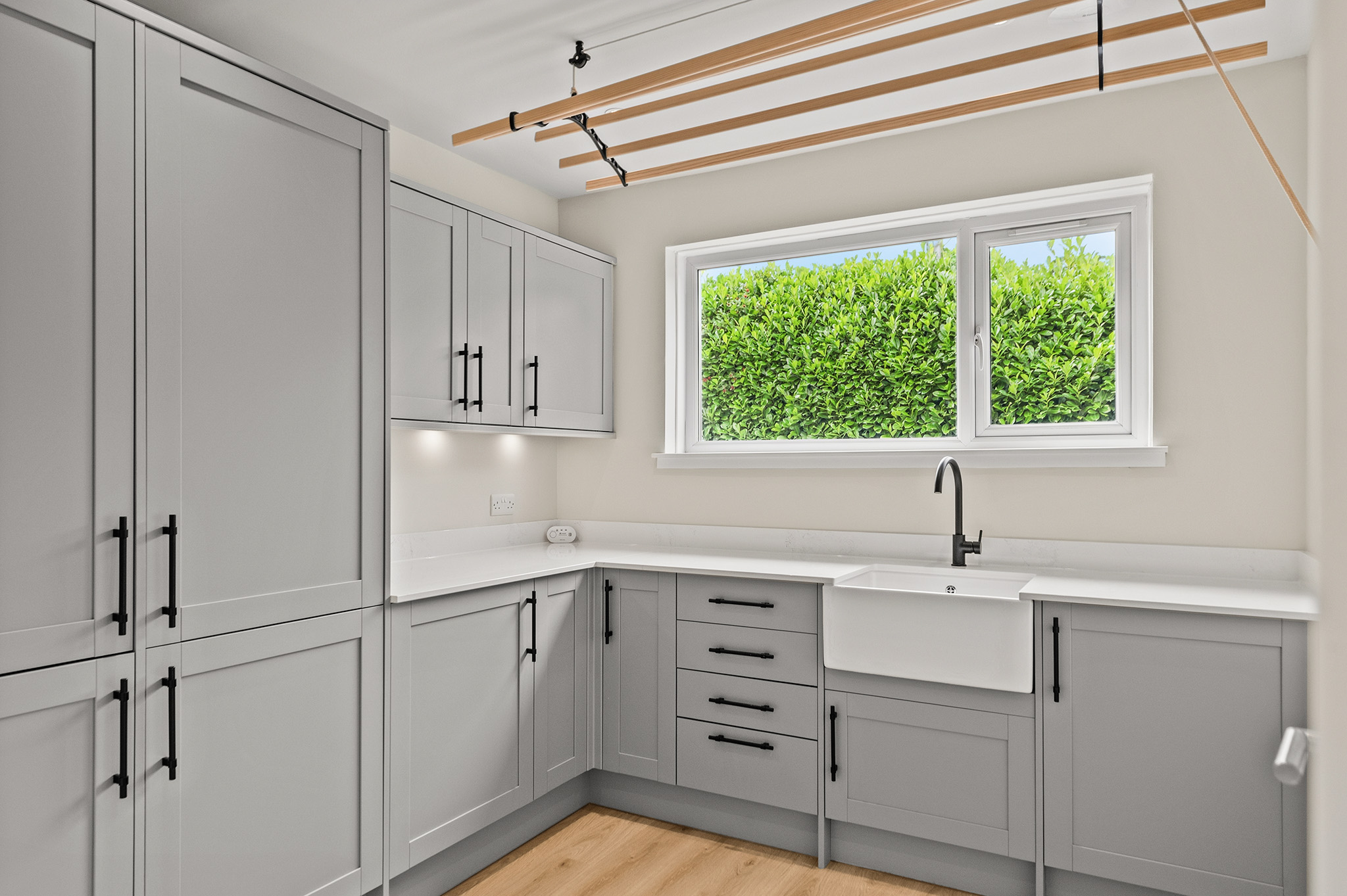 Utility room at Auchterarder with fitted units, Belfast sink and a ceiling airer