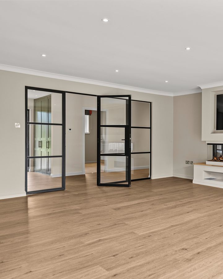 Black steel-framed glazed doors between rooms in a house in Auchterarder
