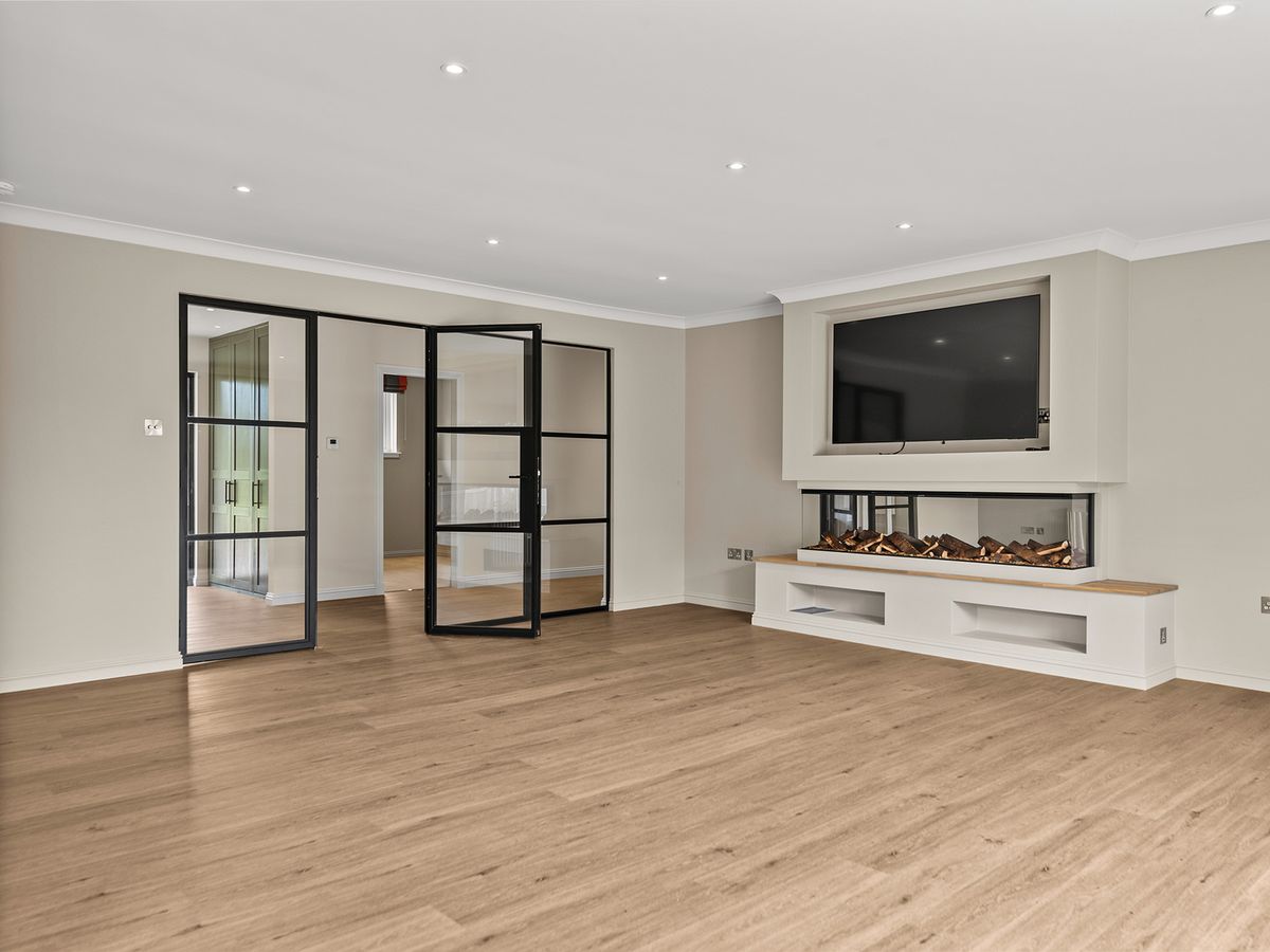 Black steel-framed glazed doors between rooms in a house in Auchterarder