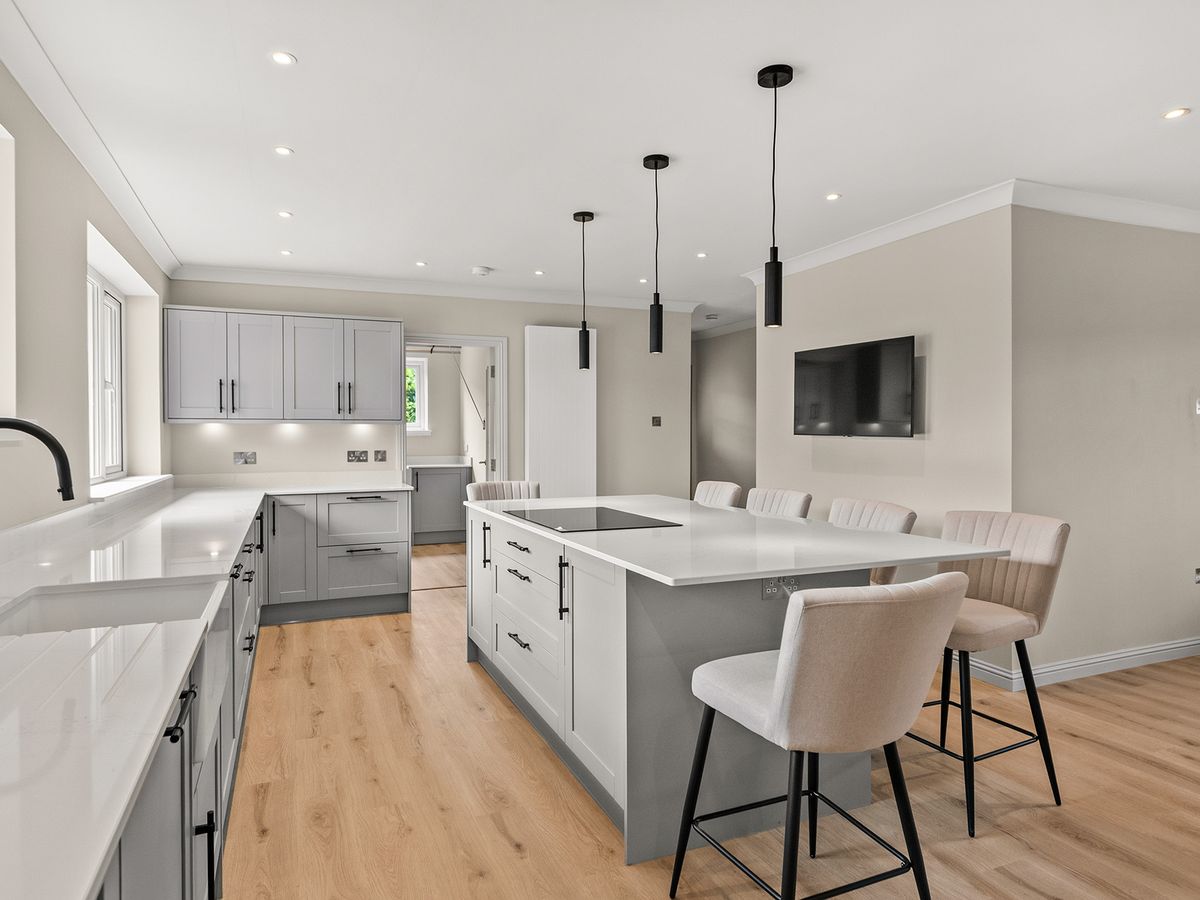 Kitchen in Auchterarder with shaker units, quartz worktops and an island with bar stools